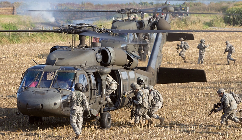 Army soldiers exiting helicopter