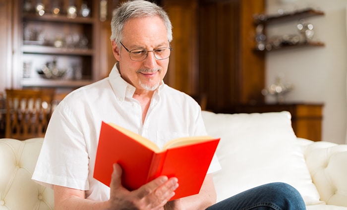 Mature man reading a book.