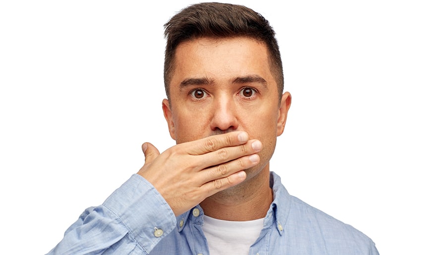 Man covering mouth due to bad breath