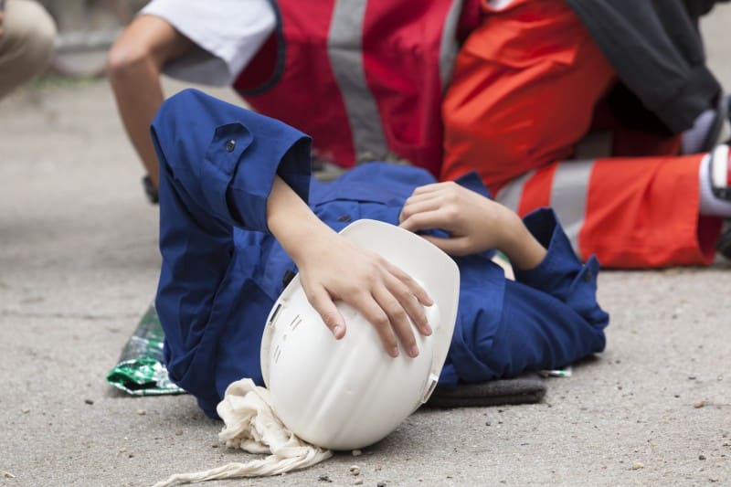 construction worker laying on the ground due to injury