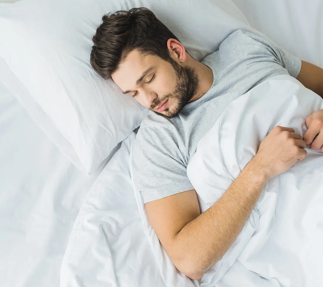 Insprire Sleep Apnea Treatment Man sleeping peacefully in bed