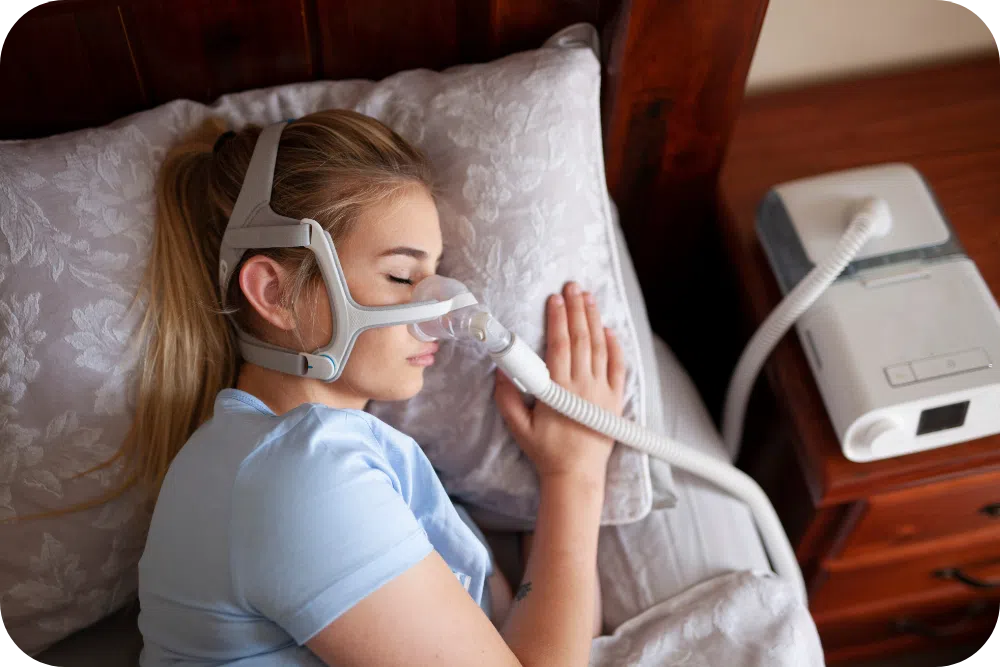 woman sleeping with CPAP machine