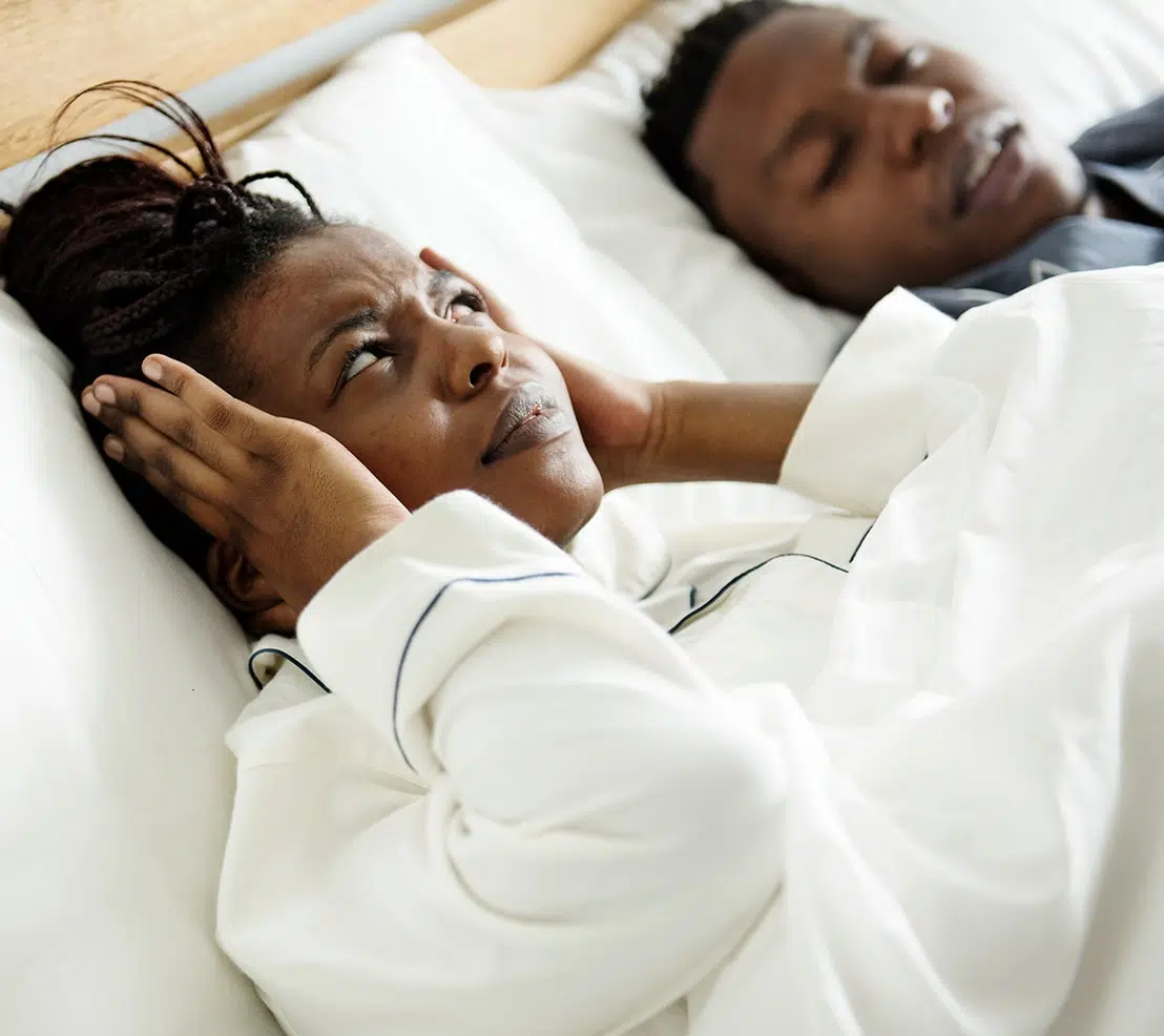 Snoring-Omaha (1) Frustrated woman covering her ears while her partner snores